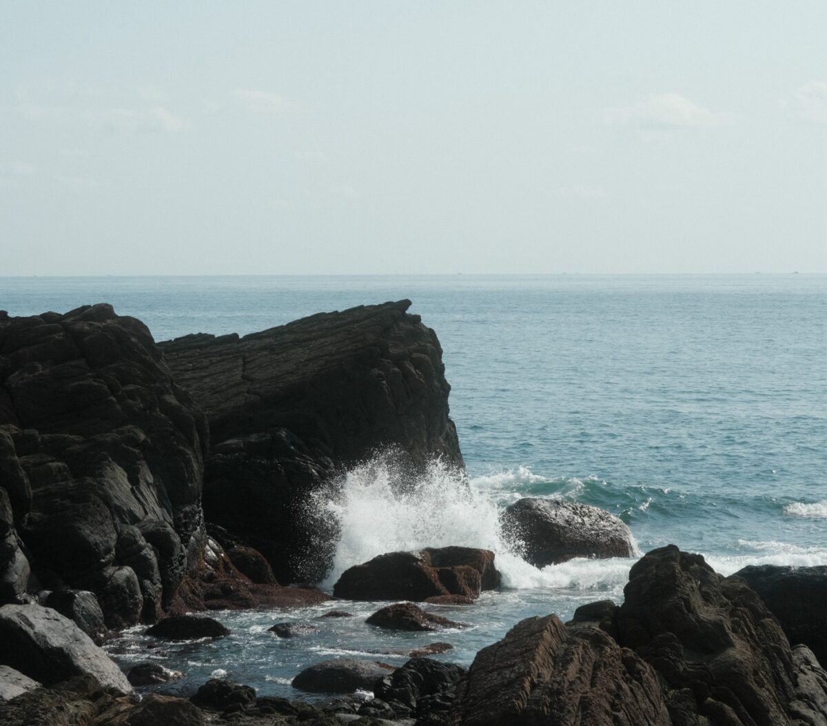 waves crashing into a rock